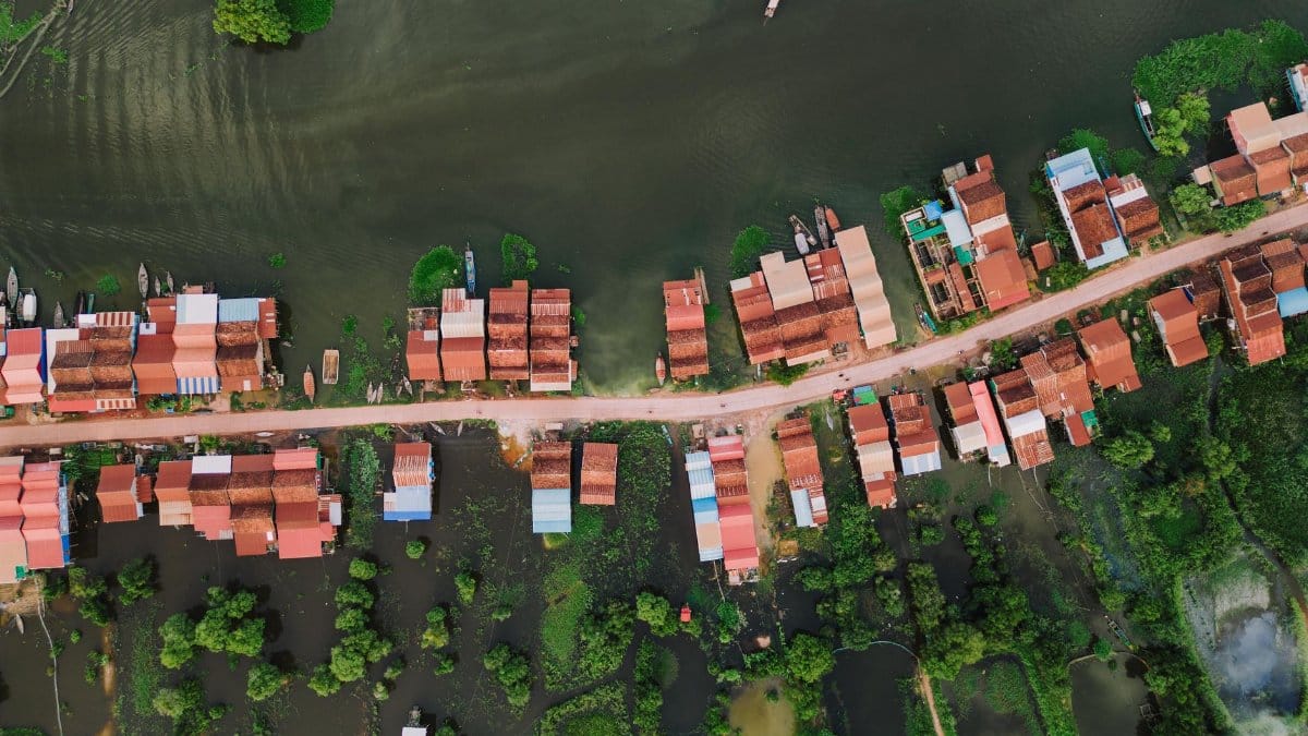 Scenic aerial view of Kampong Khleang floating village with colorful stilt houses in Cambodia.