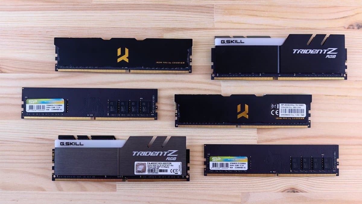 Top view of various RAM sticks arranged on a wooden surface, showcasing computer memory technology.