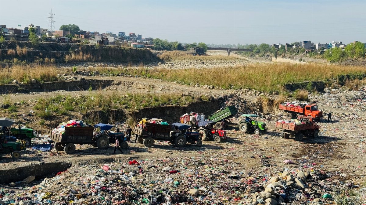 Trucks collecting waste at a landfill in Butwal, highlighting environmental and sanitation issues.