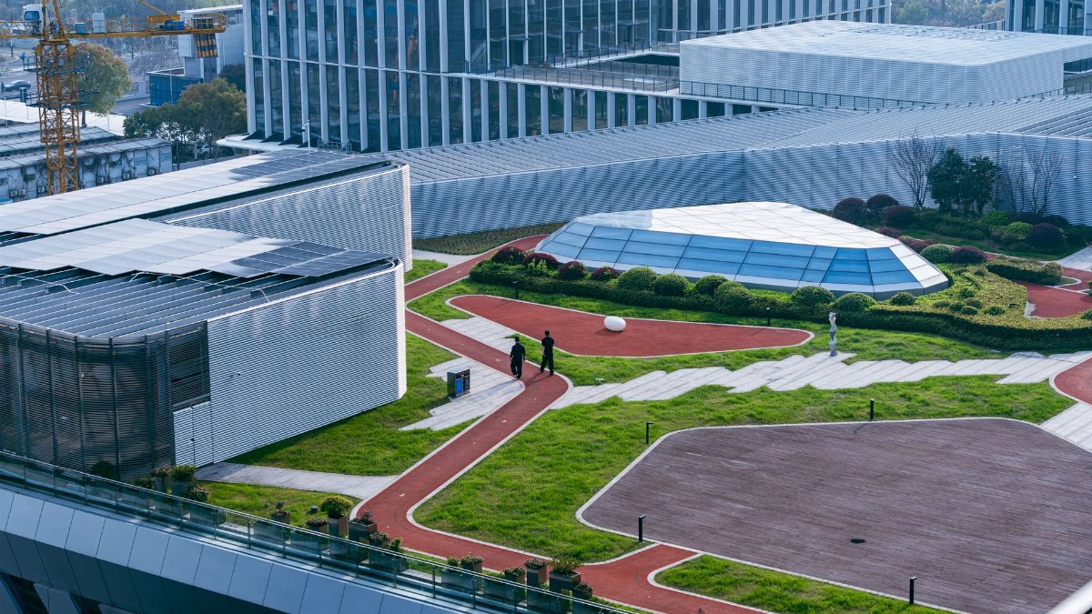 Aerial view of a contemporary rooftop garden with pathways on a modern building in Hangzhou, China.