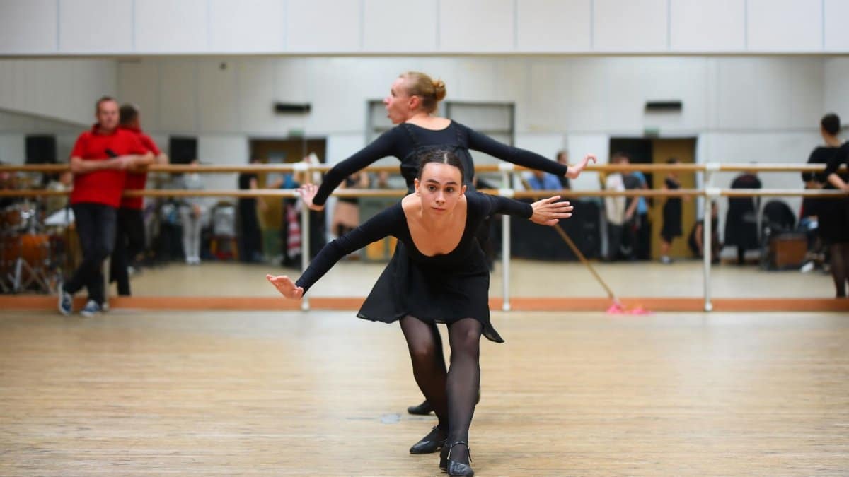 A dancer in action inside a professional dance studio, capturing movement and grace.