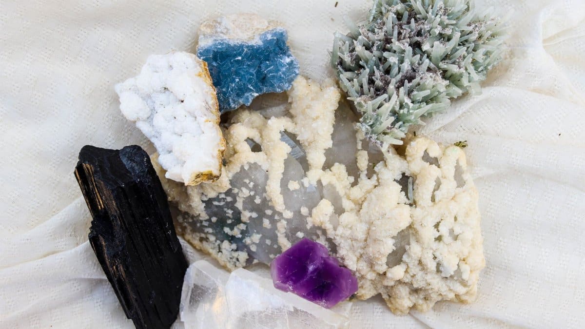 Diverse mineral specimens including amethyst and quartz on display.