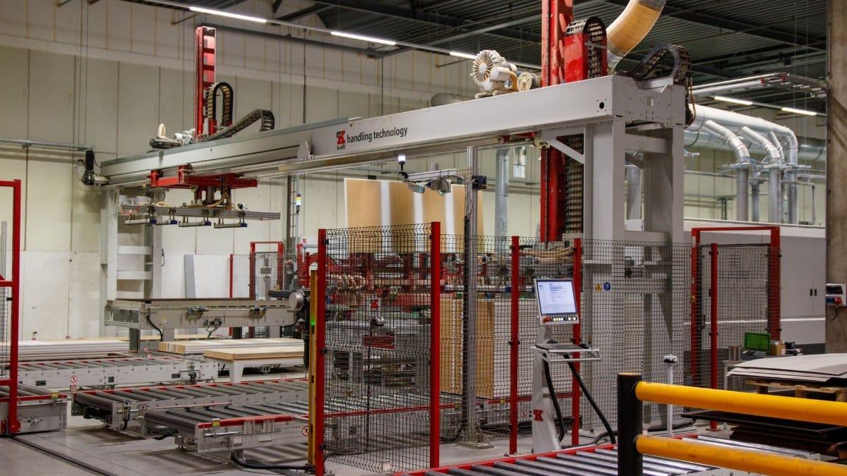 Industrial machinery with robotic arm in a modern manufacturing facility.