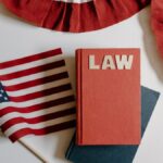 American flag with a law book, symbolizing independence and politics.