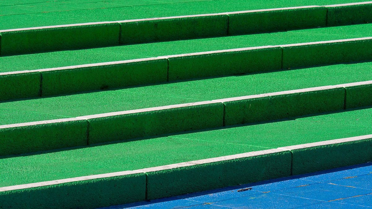 Vibrant green and blue steps create a modern urban design with strong geometric patterns.