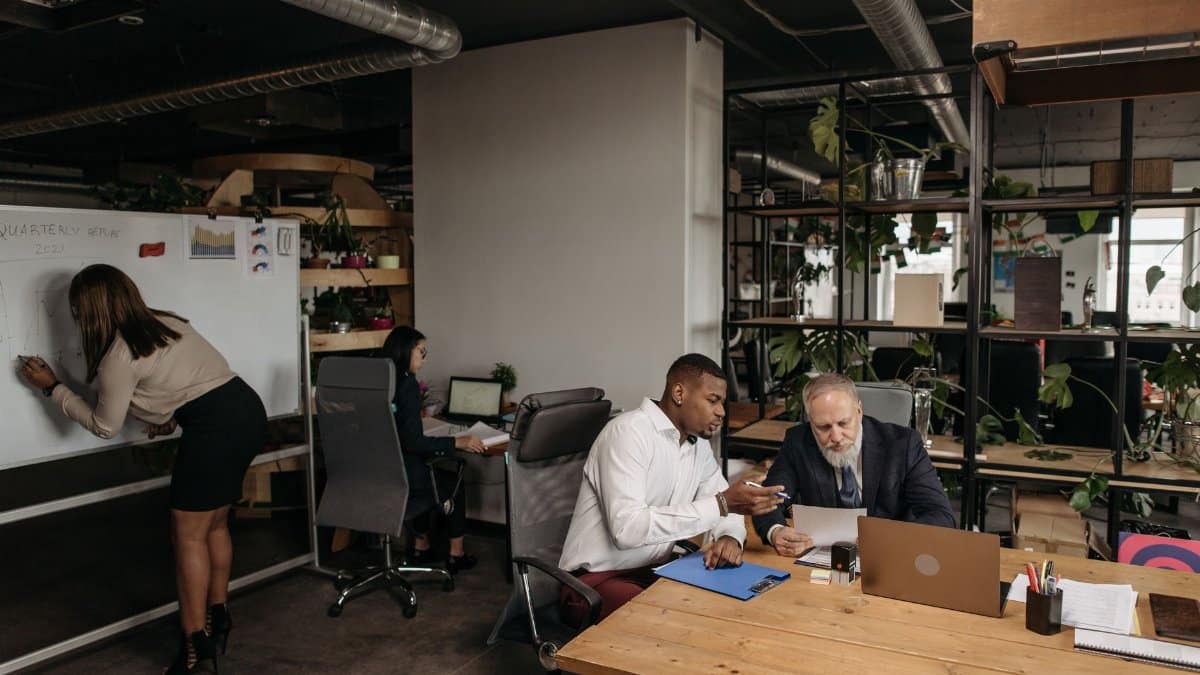 Diverse team collaborating in a modern office environment, planning strategy.