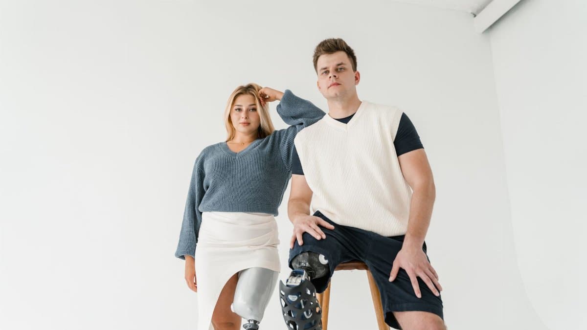 Stylish portrait of models in prosthetic limbs highlighting modern fashion and inclusion.