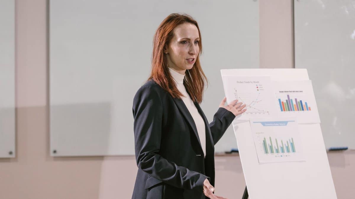 Confident businesswoman delivers presentation with charts at a professional conference.
