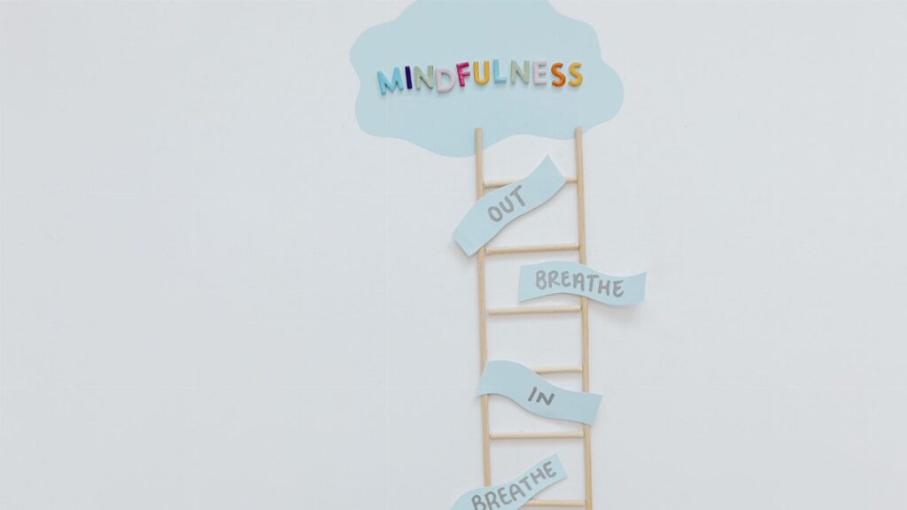 Creative mindfulness concept with ladder, words, and cloud shape for mental well-being.