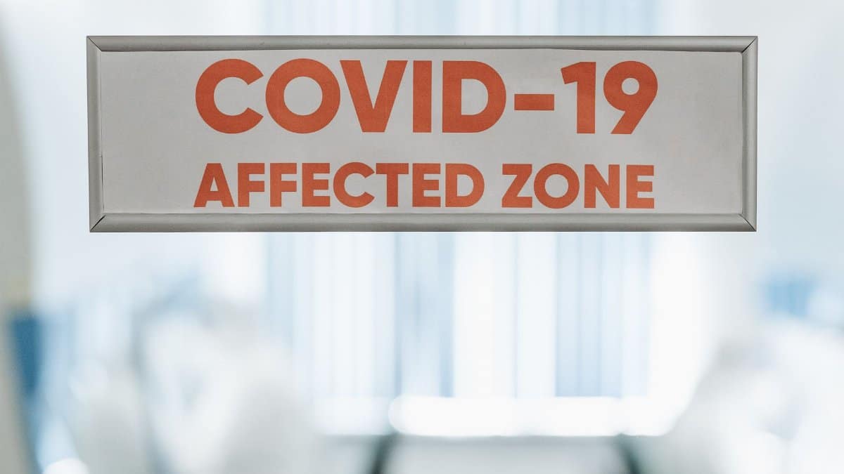 Signage indicating a COVID-19 affected zone in a medical facility, highlighting health safety.