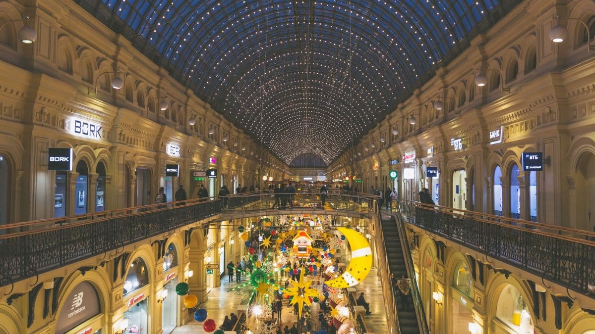 Beautifully decorated GUM shopping mall in Moscow with festive lights and holiday decorations.
