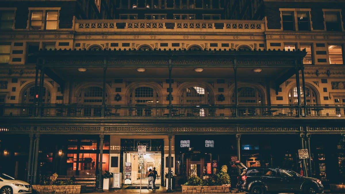 A beautifully illuminated historic building facade captured at night on a street in Houston, Texas.