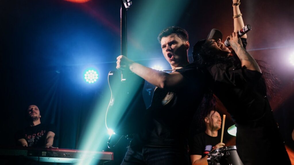 Dynamic concert with a band performing lively rock music on stage.