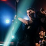 Dynamic concert with a band performing lively rock music on stage.
