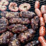 Delicious Argentine sausages and meat grilling at an outdoor asado in Uribelarrea.