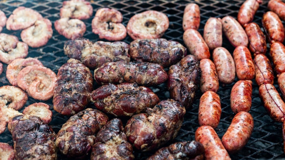 Delicious Argentine sausages and meat grilling at an outdoor asado in Uribelarrea.