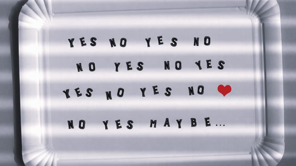 Paper tray with playful text phrases and a red heart, captured with shadows.