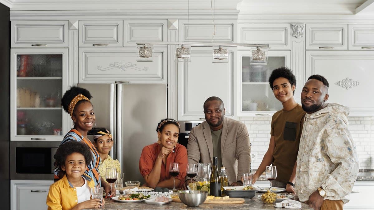 A happy family enjoying a meal together in a modern kitchen setting.