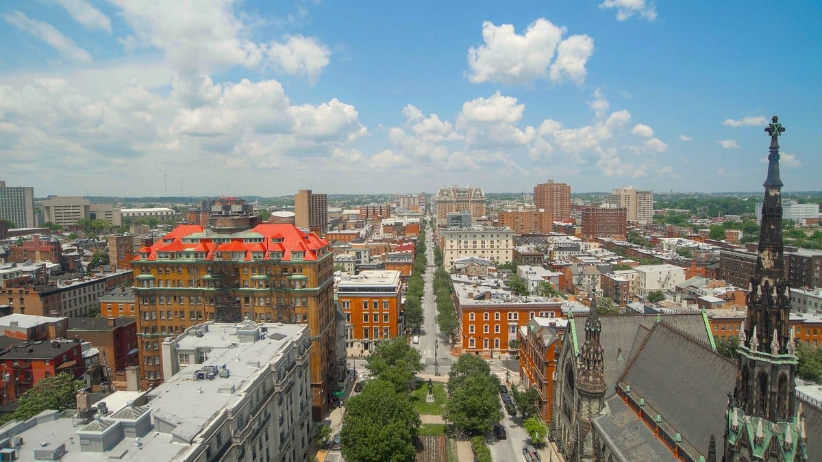 A vibrant aerial view of Baltimore featuring a historic church spire and urban landscape.
