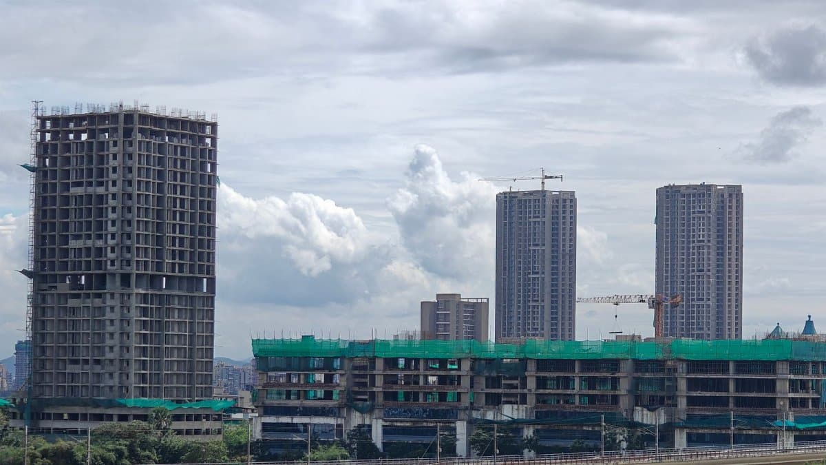 Cityscape featuring high-rise buildings under construction with cranes.