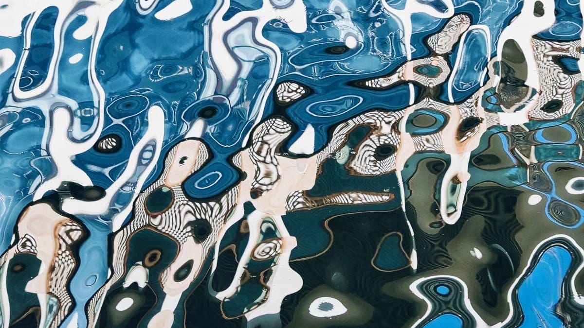 Artistic abstract image of water reflection creating blue and white patterns.