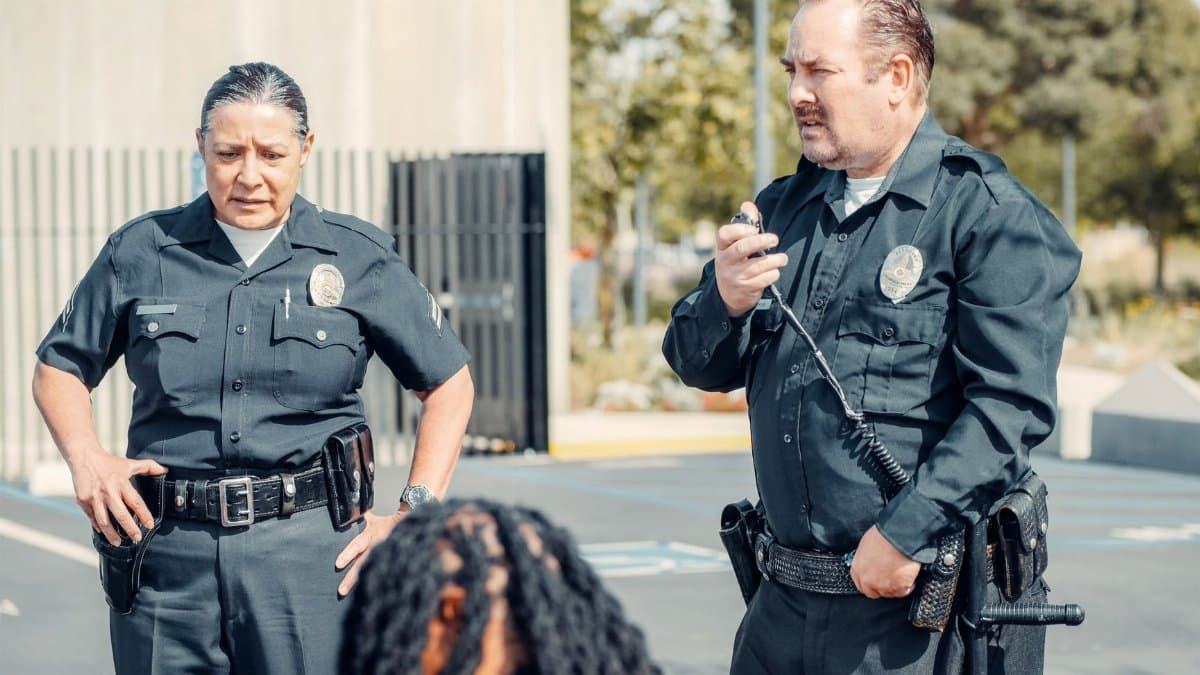 Two police officers interacting at a crime scene, focusing on communication and law enforcement duties.
