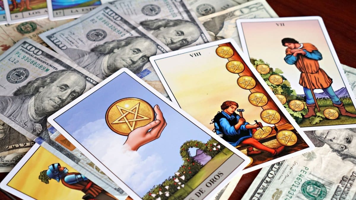 Tarot cards placed on US dollar bills, symbolizing wealth, fortune, and financial divination.