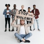 A group of people holding a sign advocating to stop violence, conveying unity.