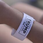 A close-up of a wristband showing political support for 'TRUMP 2024.'