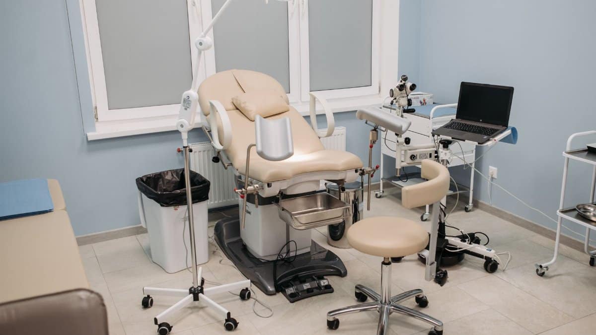 Clean and well-equipped medical office featuring an examination chair and various medical tools.