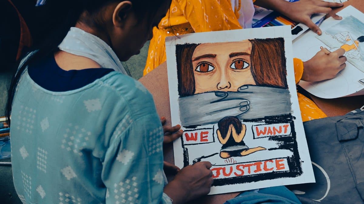 A young girl creates powerful protest art to raise awareness for women's justice in Kolkata, India.