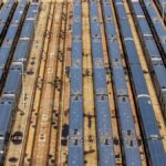 Aerial view of a busy train yard in New York City showcasing multiple trains parked in parallel tracks.