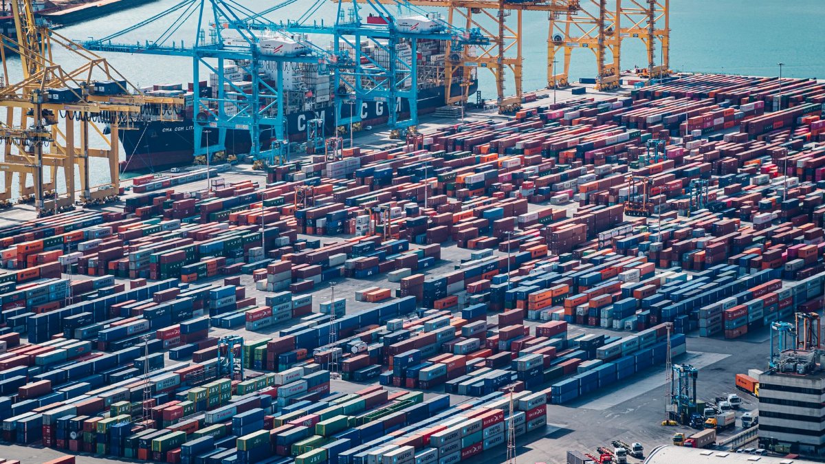A drone shot of shipping containers at Barcelona Port, Spain, showcasing busy maritime activity.