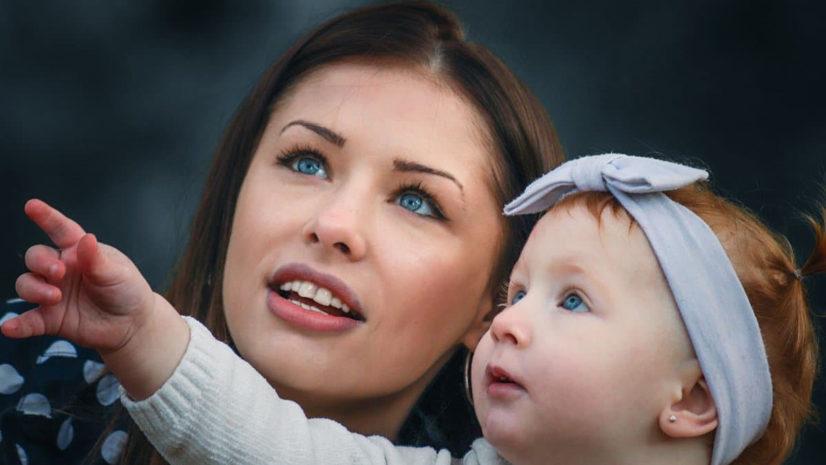 A touching portrait of a mother and her baby engaging with curiosity and wonder.