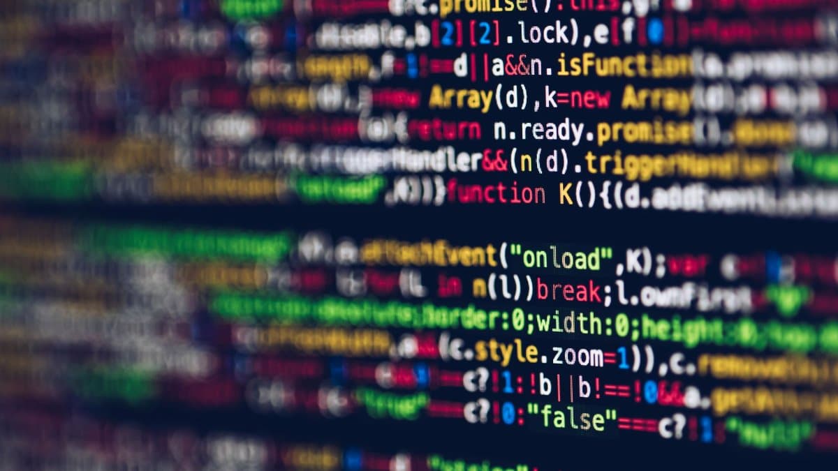 Vivid, blurred close-up of colorful code on a screen, representing web development and programming.