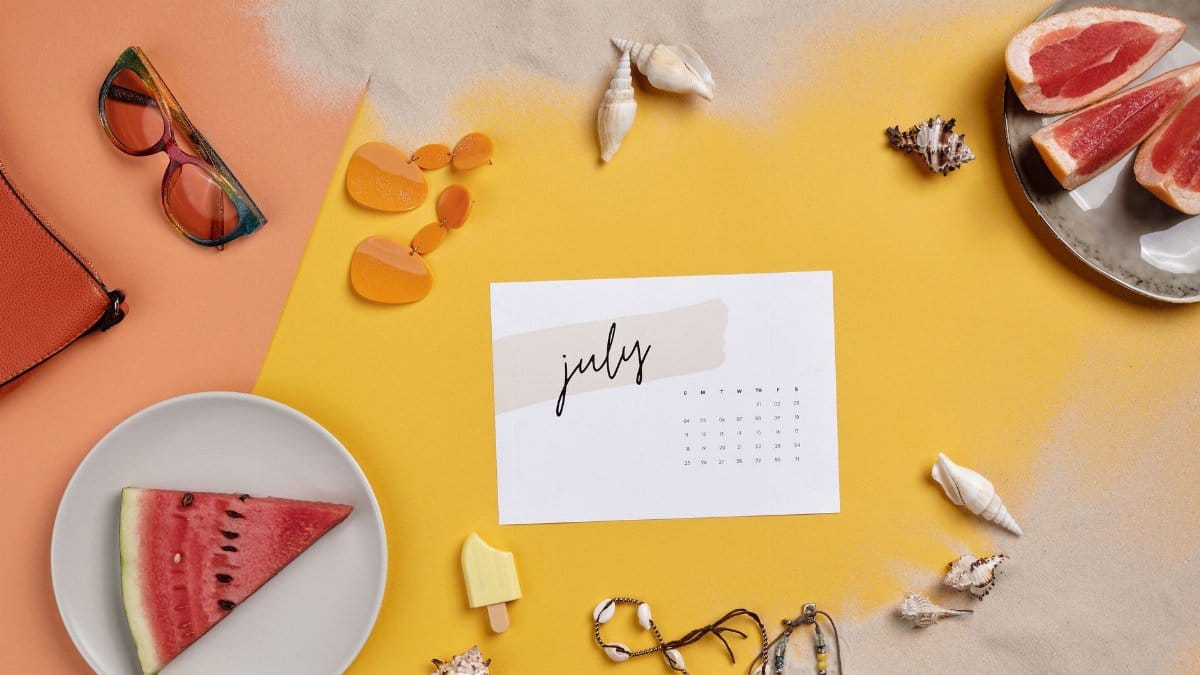 Colorful summer-themed flat lay with watermelon, sea shells, and July calendar.
