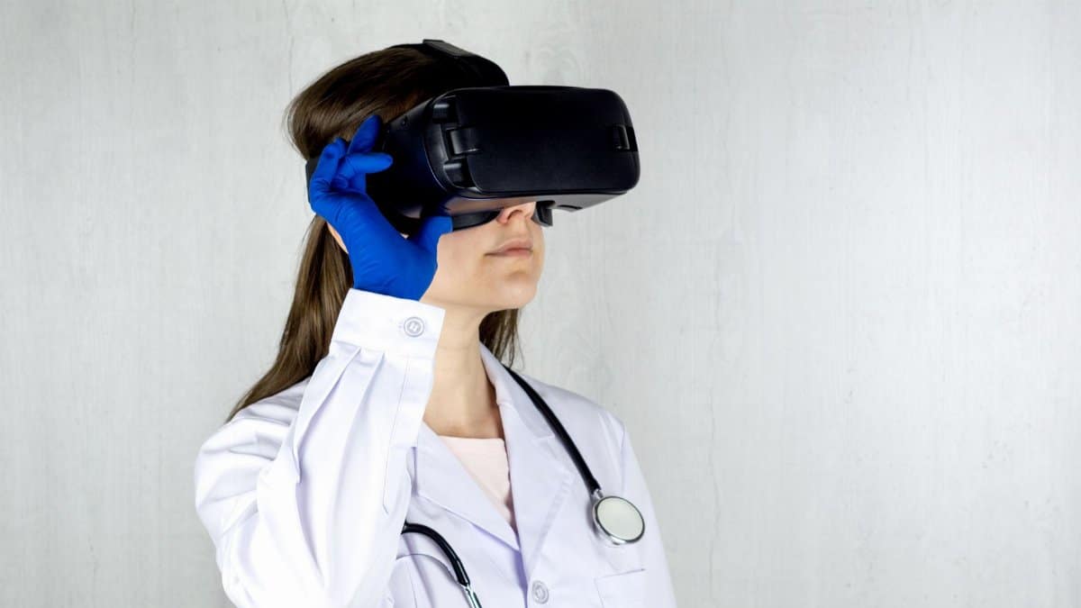 Doctor in a lab coat exploring virtual reality technology with goggles.