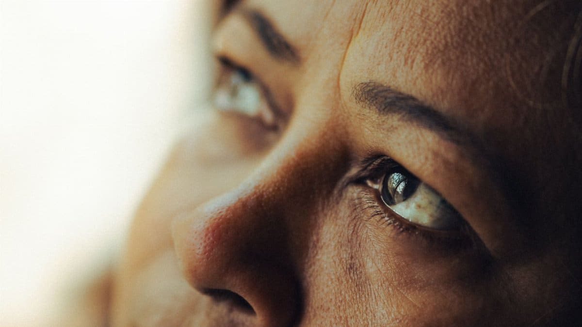 Intimate close-up shot of a woman's eyes reflecting deep thought and emotion.