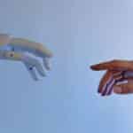 A human hand reaching towards a robotic hand symbolizing technology and connection.