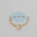Minimalist image of a wooden figure holding a speech bubble saying 'Mindfulness'.