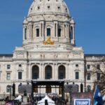 Crowd gathers at Minnesota State Capitol for protest in springtime.