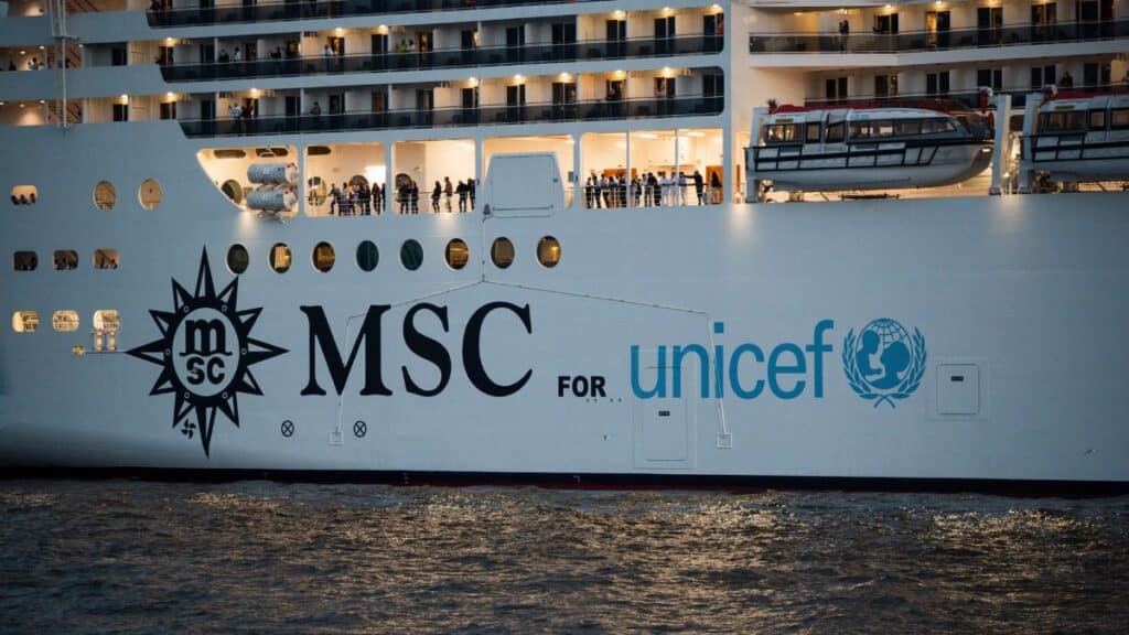 MSC cruise ship displaying its collaboration with UNICEF during an evening voyage on water.