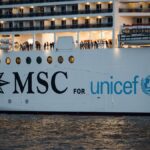 MSC cruise ship displaying its collaboration with UNICEF during an evening voyage on water.