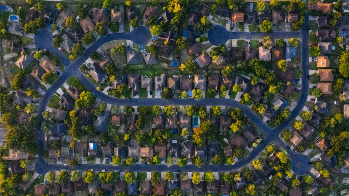 Aerial shot of suburban neighborhood in Edinburg, Texas, highlighting roads and houses.