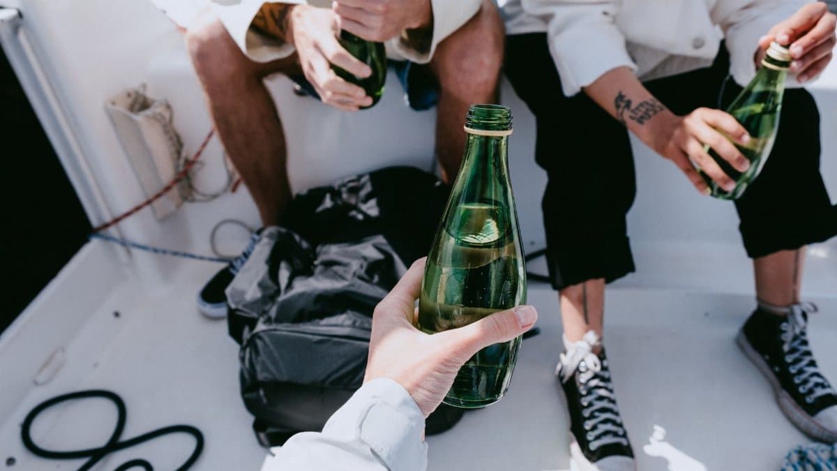 Casual gathering of friends enjoying nonalcoholic drinks on a yacht at sea.