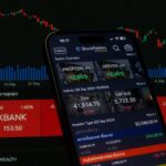 Close-up of a digital stock trading app interface with investment charts and market trends displayed.
