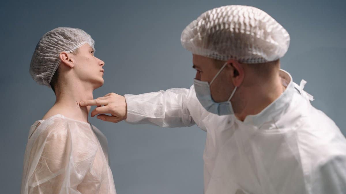A doctor evaluates a patient's skin condition in a clinical setting with appropriate medical attire.