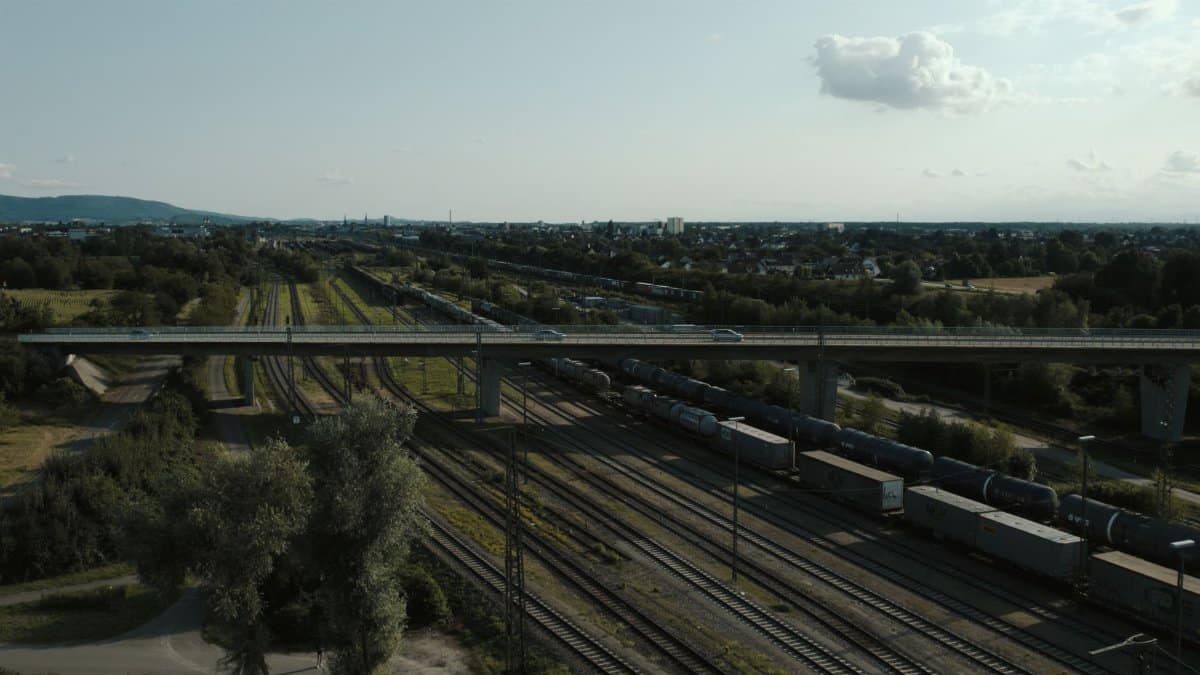 Aerial view showcasing a railway with freight train in a scenic landscape near Offenburg, Germany.