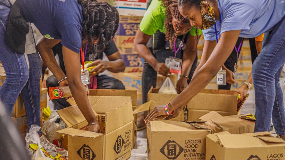 Team of volunteers sorting and packing food donations for a local charity initiative.