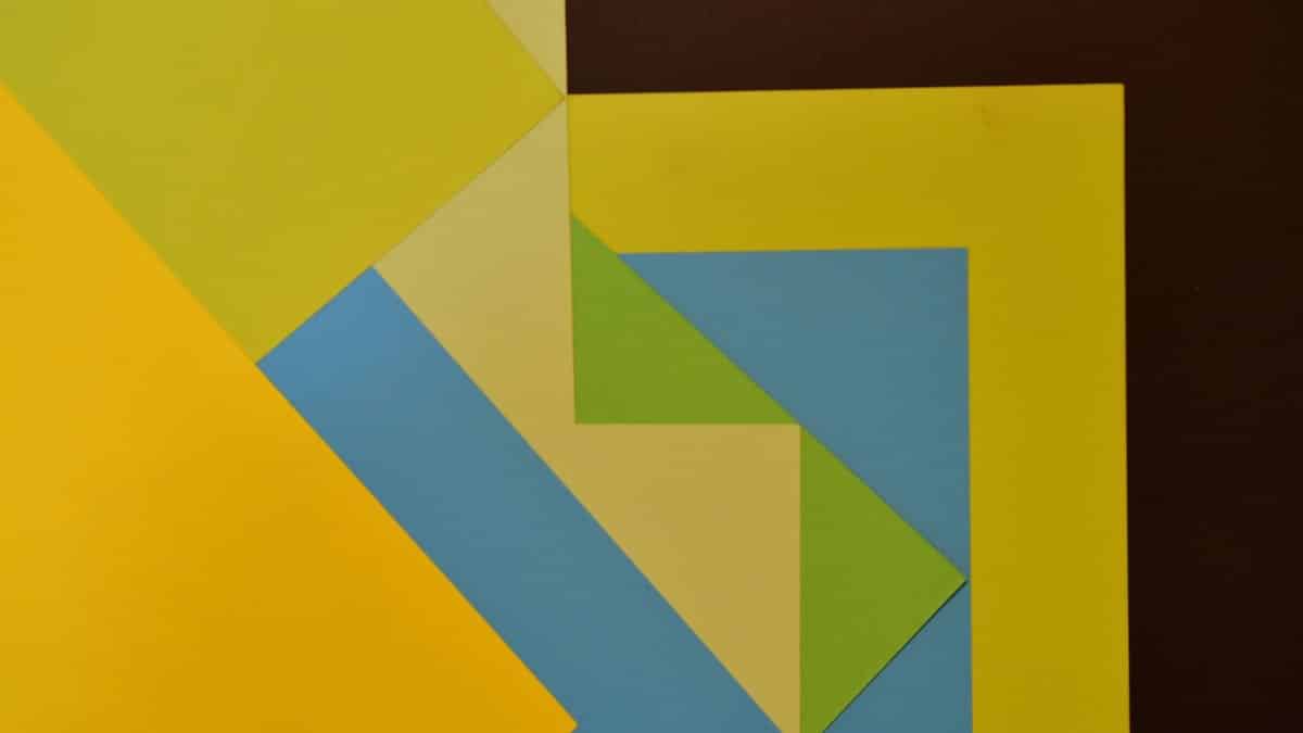 Vibrant abstract composition of colorful geometric paper shapes creating a modern art piece.